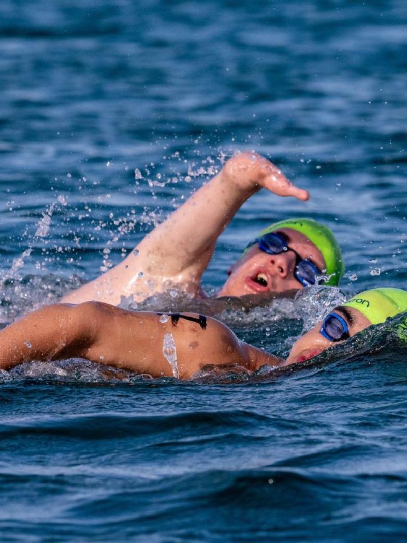 Two Para swimmers in an open water competition