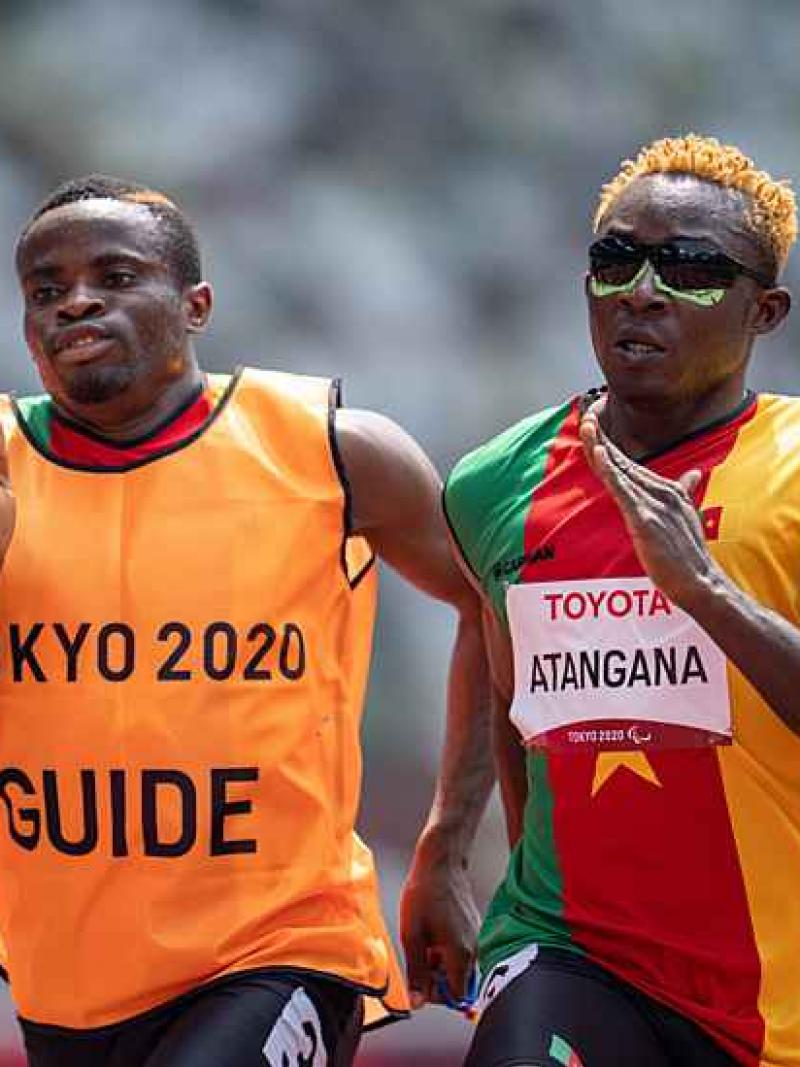 Vision impaired sprinter Guillaume Junior Atangana running with his guide