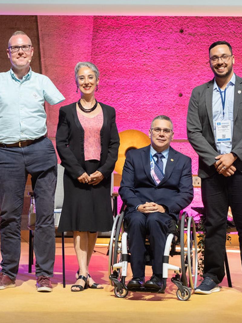 A group of people with disabilities standing on a stage