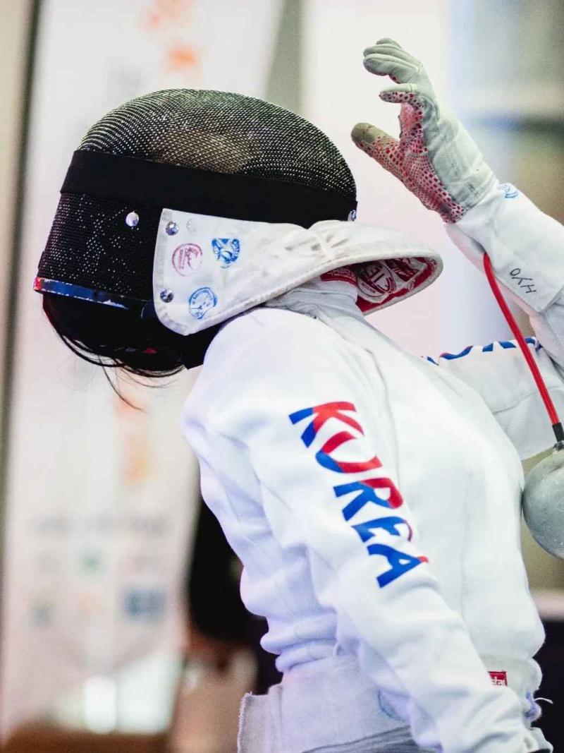 a south korean female wheelchair fencer in action 