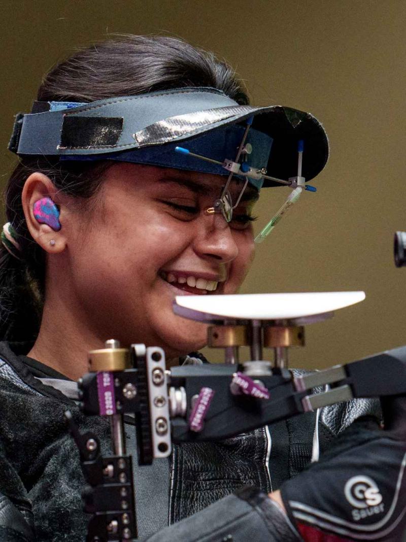 An athlete gestures after winning a rifle event 