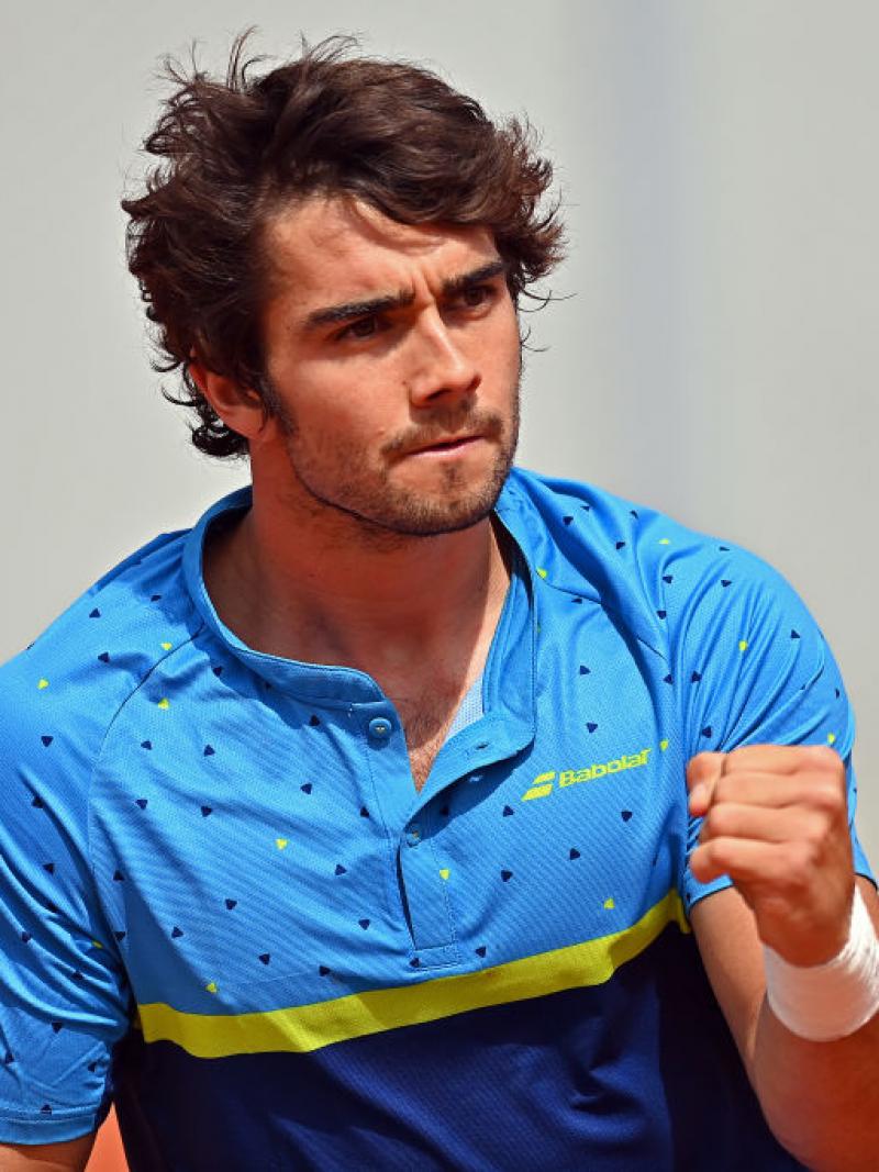 The Spanish wheelchair tennis player Daniel Caverzaschi, wearing a blue shirt, punches the air in celebration