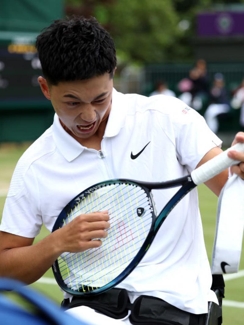 Tokito Oda playing air guitar with his racquet 