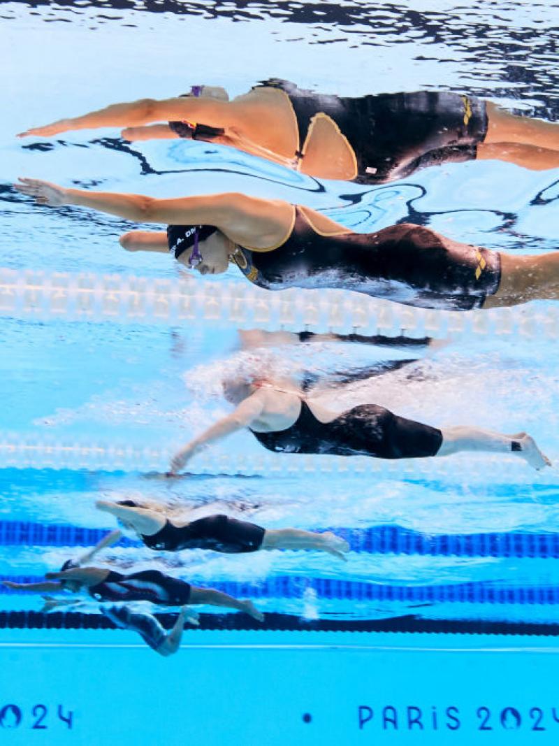 An underwater image of four female swimmers in a pool