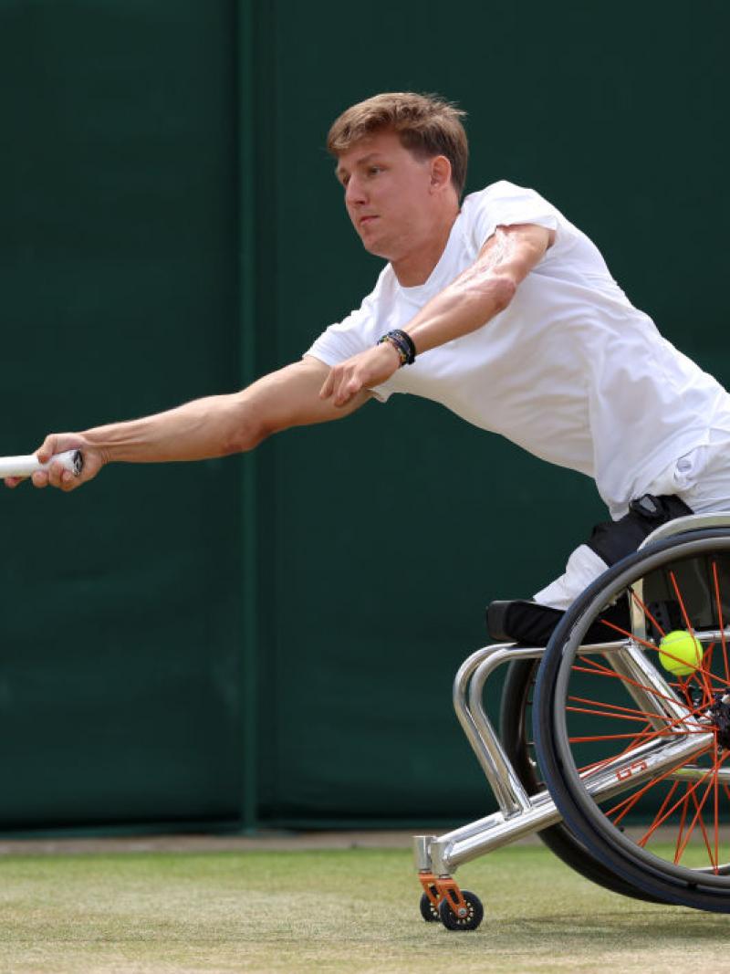 A male wheelchair tennis player in action