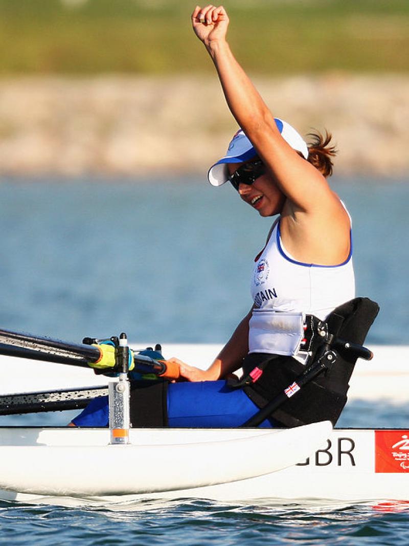 A female Para rowing athlete reacts after a competition