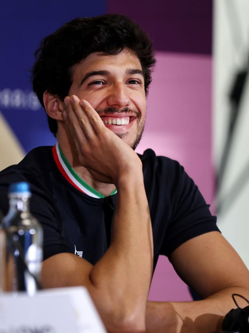 A man with a hand on his face during a press conference