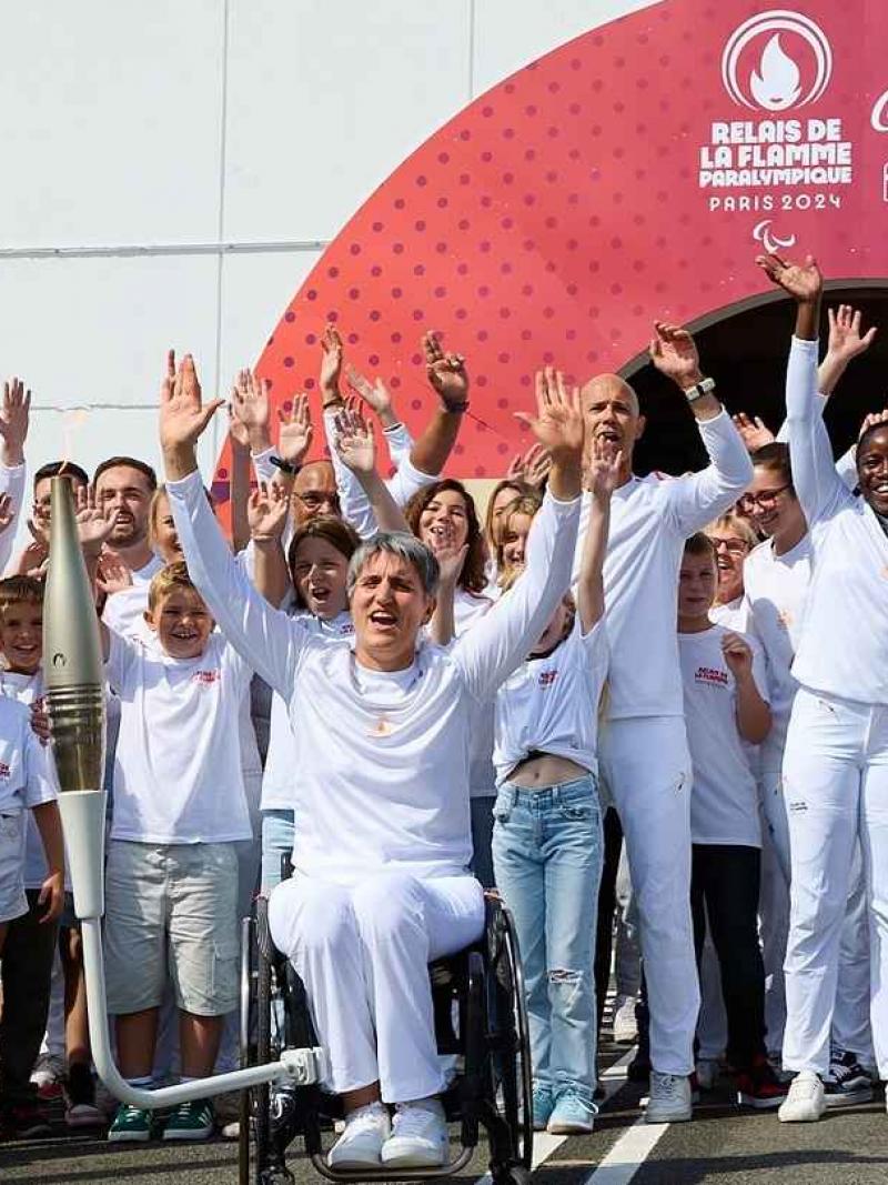 a group of Para athletes cheering outside the Channel Tunnel 