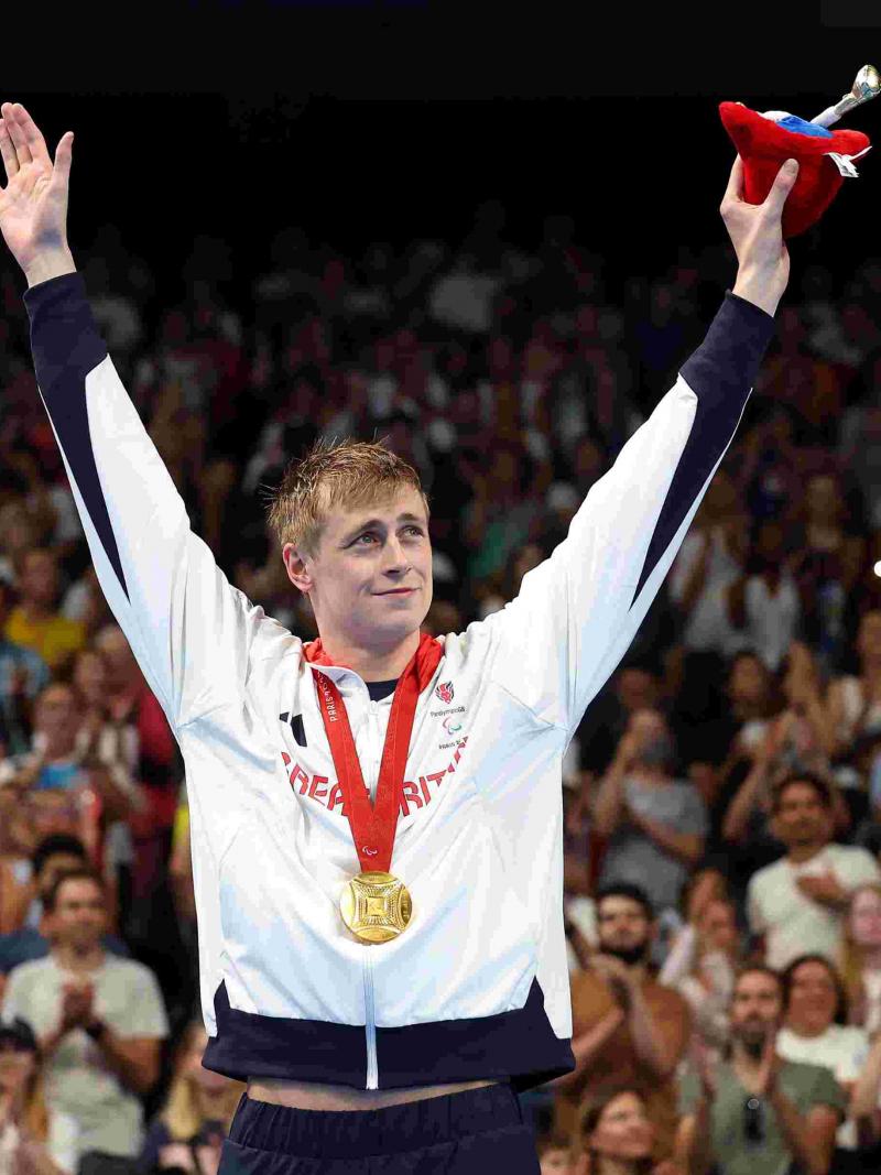An athlete celebrates on podium
