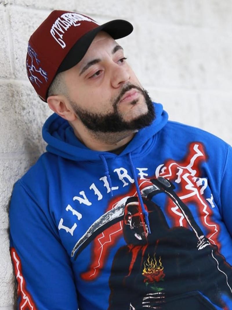 Rising Phoenix rapper George Doman leaning against a wall 