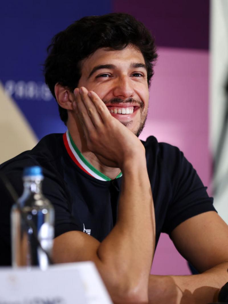 Para swimmer Simone Barlaam smiling and resting his face on his hand