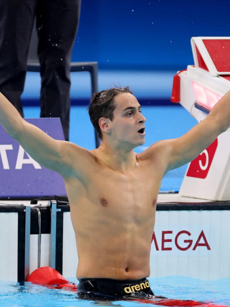 Ugo Didier holds his arms out wide as the crowd cheers 