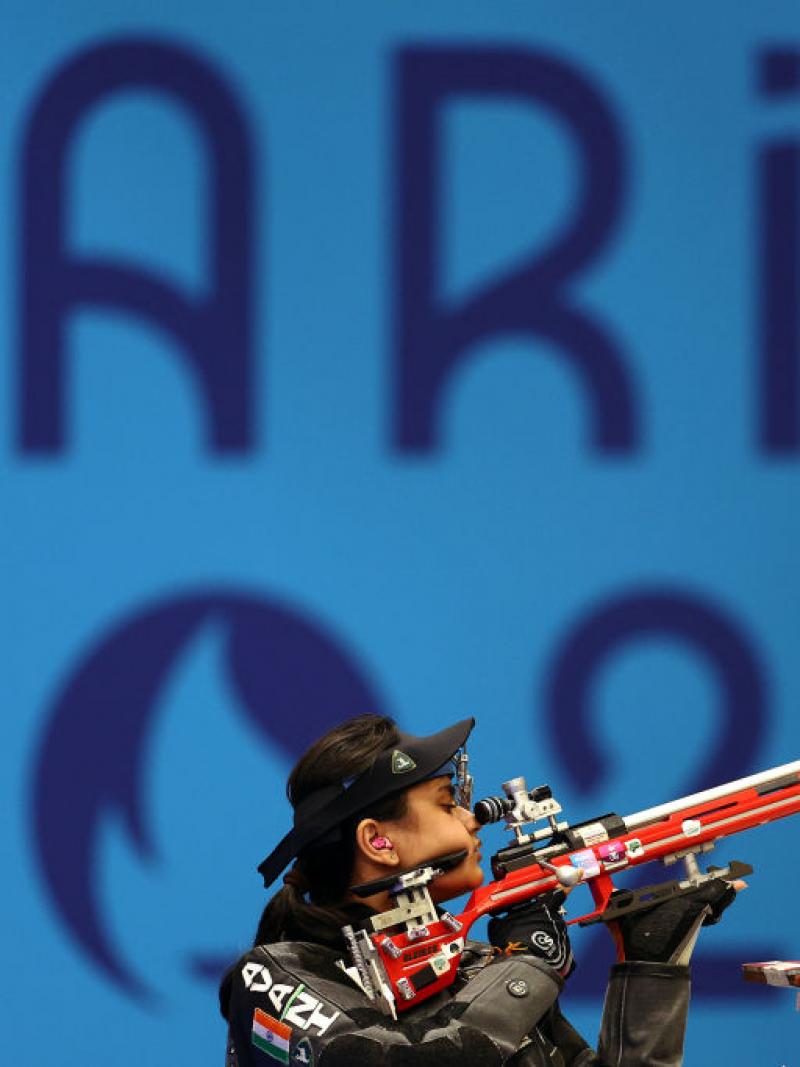 A female shooter with a rifle in a competition at Paris 2024