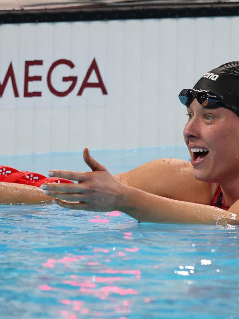 A female swimmer stretching her arms inside the pool