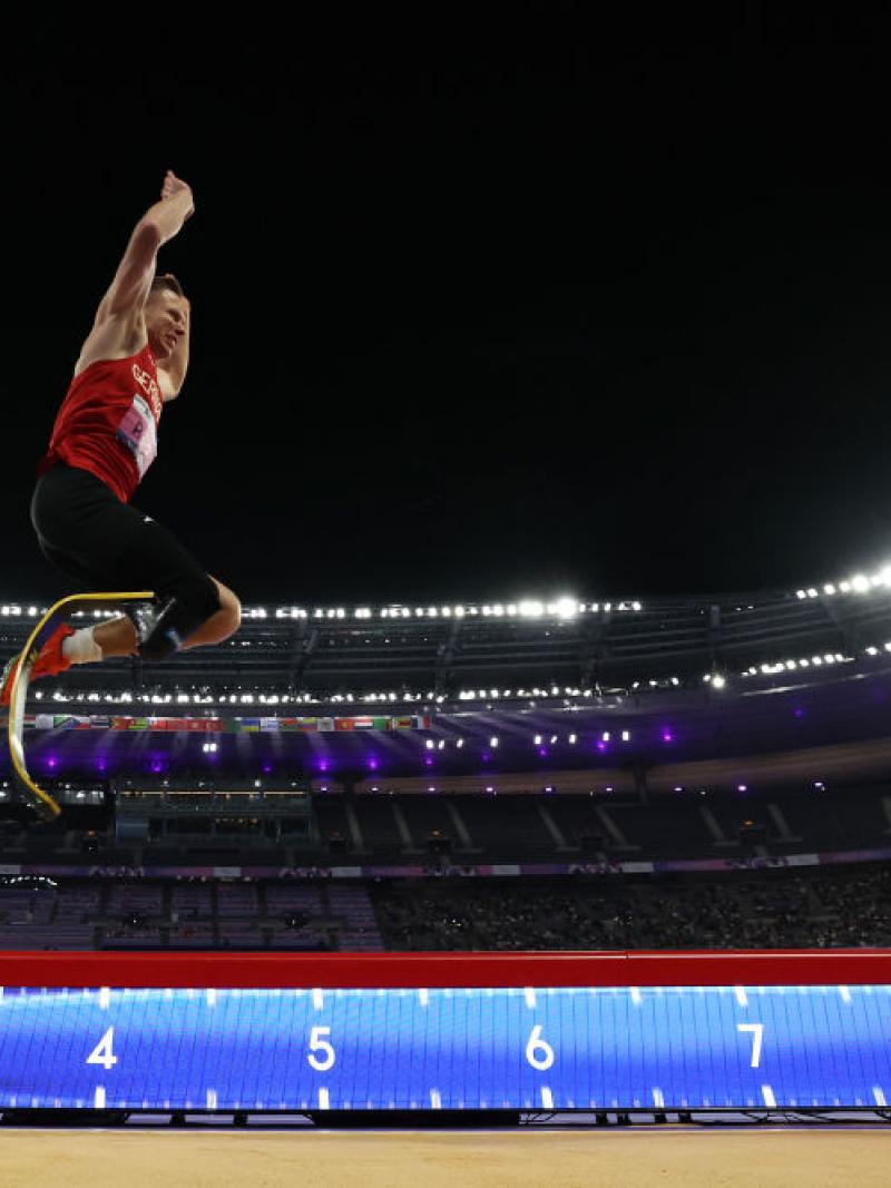 A man with a prosthetic leg competing in the long jump at Stade de France