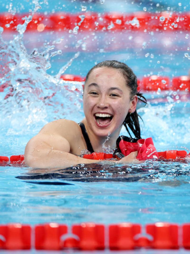 A woman in a swimming pool smiles