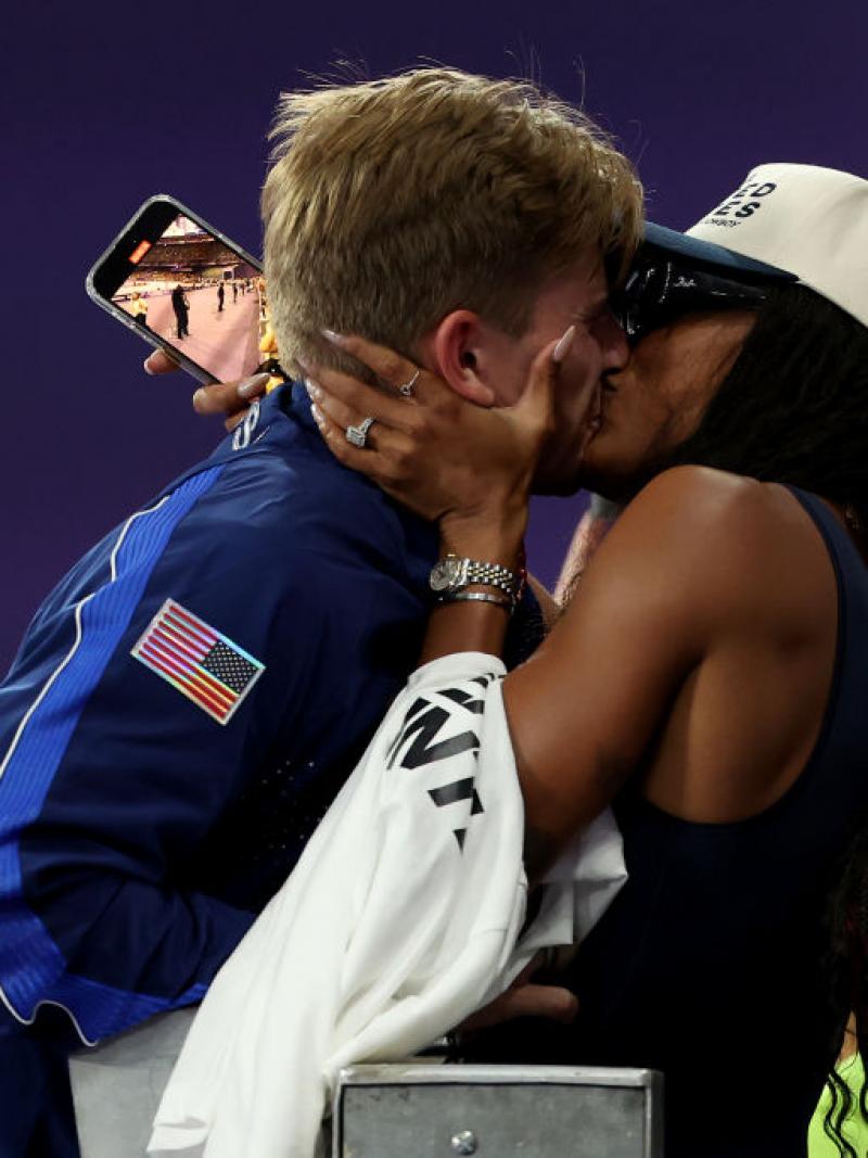 A man and a woman kissing in a stadium
