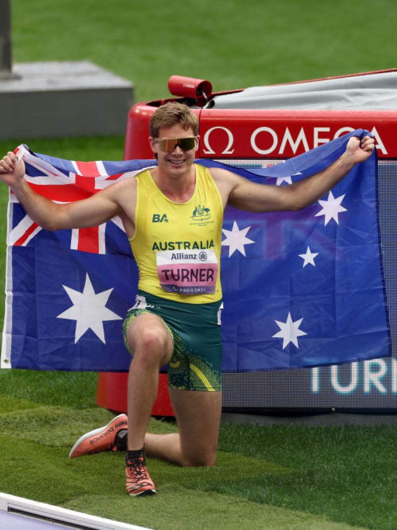 James Turner poses for a photo in front of the board that shows he broke the world record.