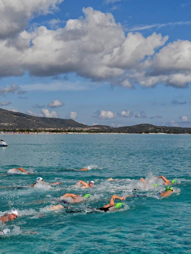 A group of swimmers in an open water event in Sardinia