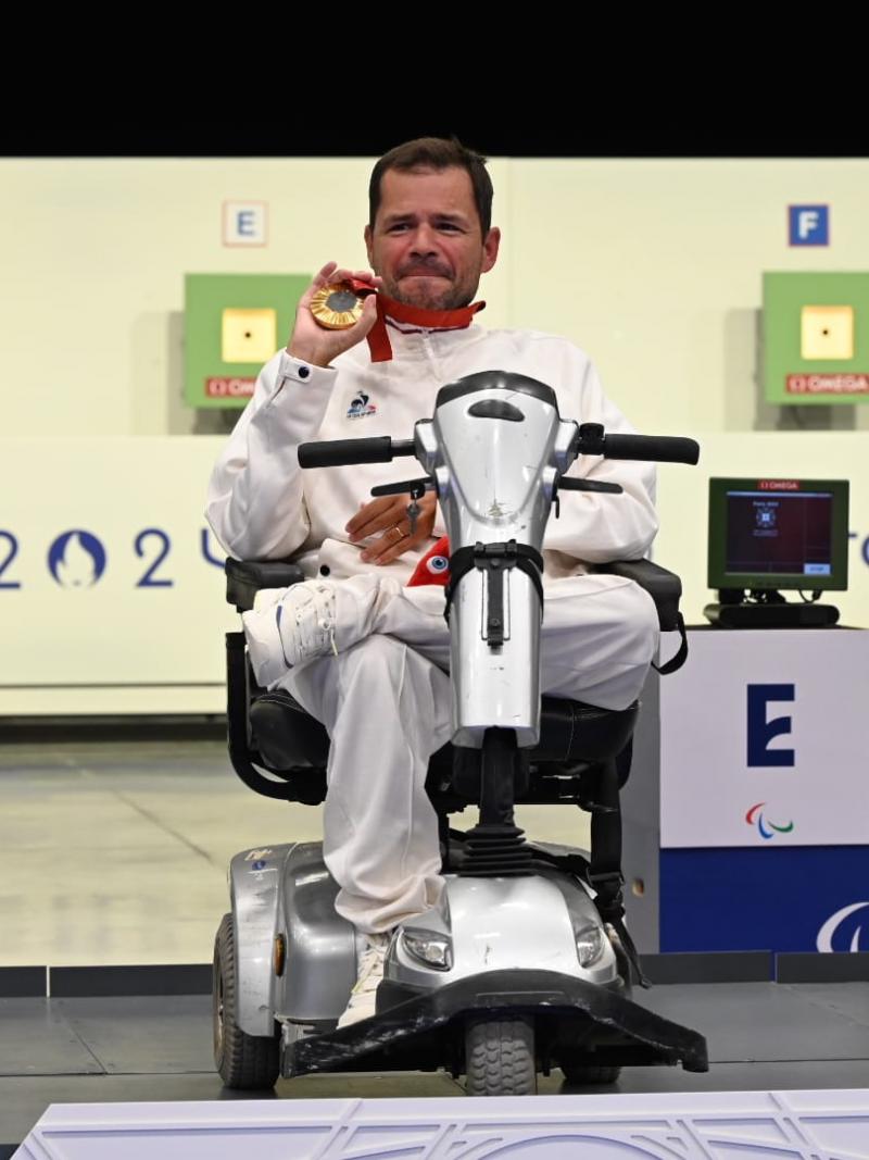 An athlete shows his medal