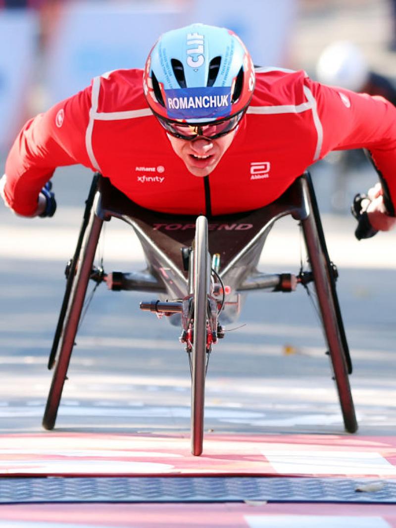 A male wheelchair racer crossing the finish line in the 2024 New York City Marathon