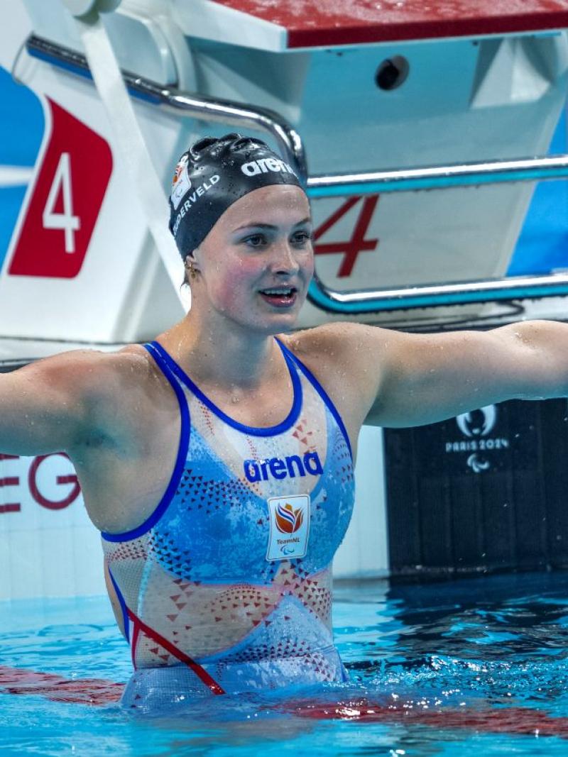 A female Para swimmer stretching her arms in the pool