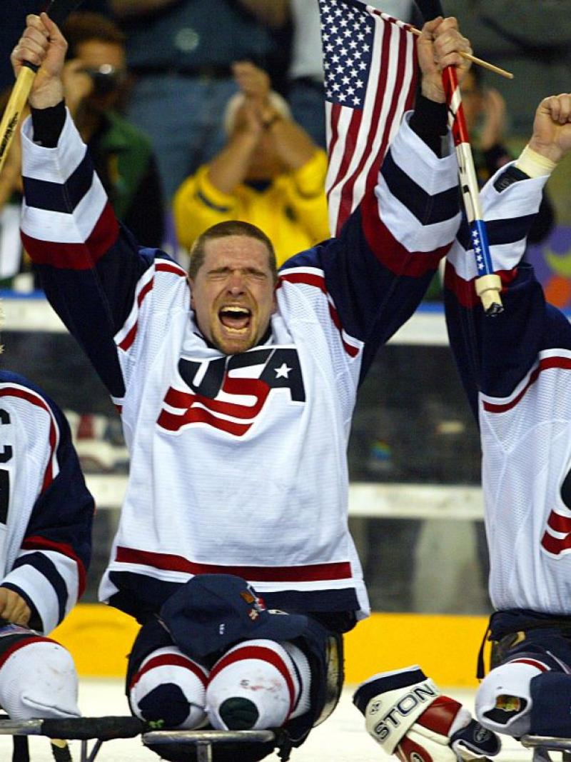 Three USA Para ice hockey players celebrating