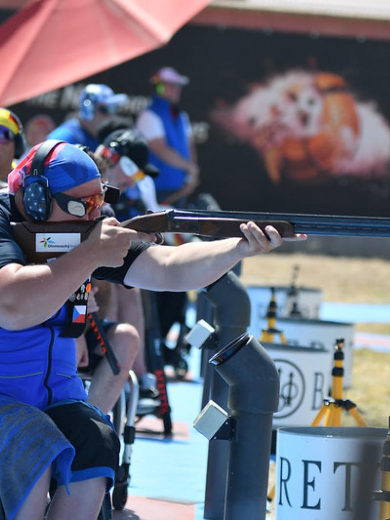 A man in a wheelchair competing in a Para trap shotgun event