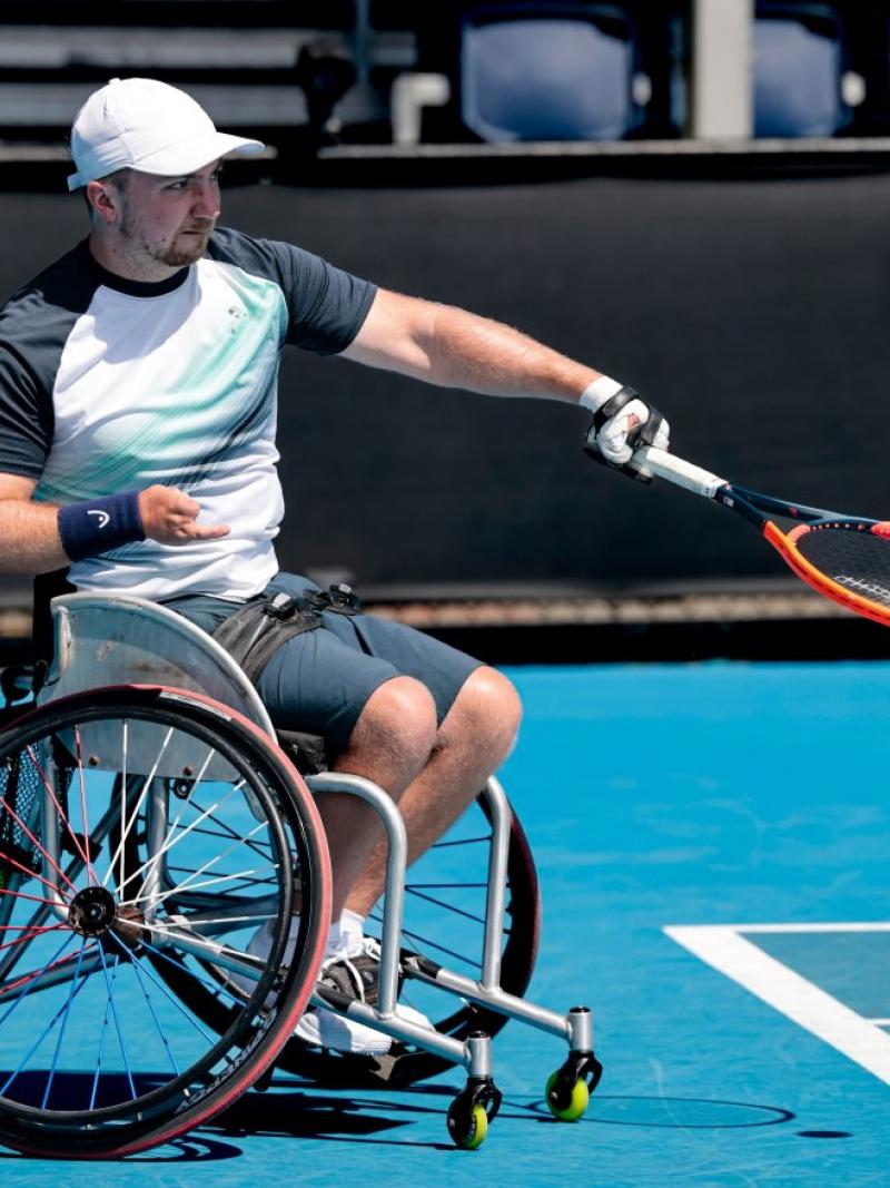 A male wheelchair tennis player in action
