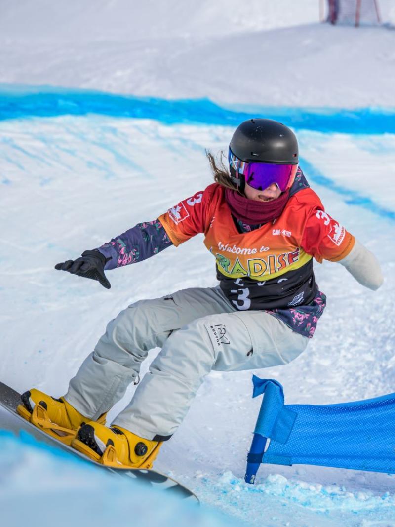A female Para snowboarding athlete in action