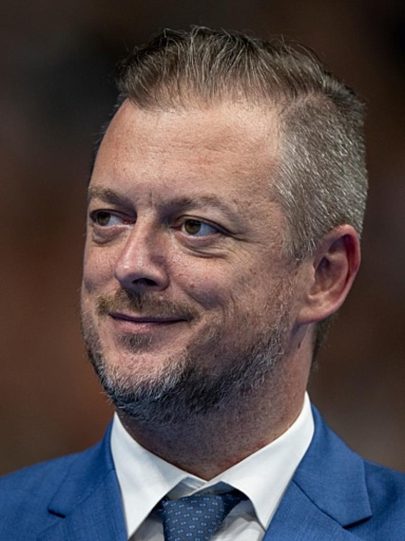 Andrew Parsons, IPC president, looks to his right