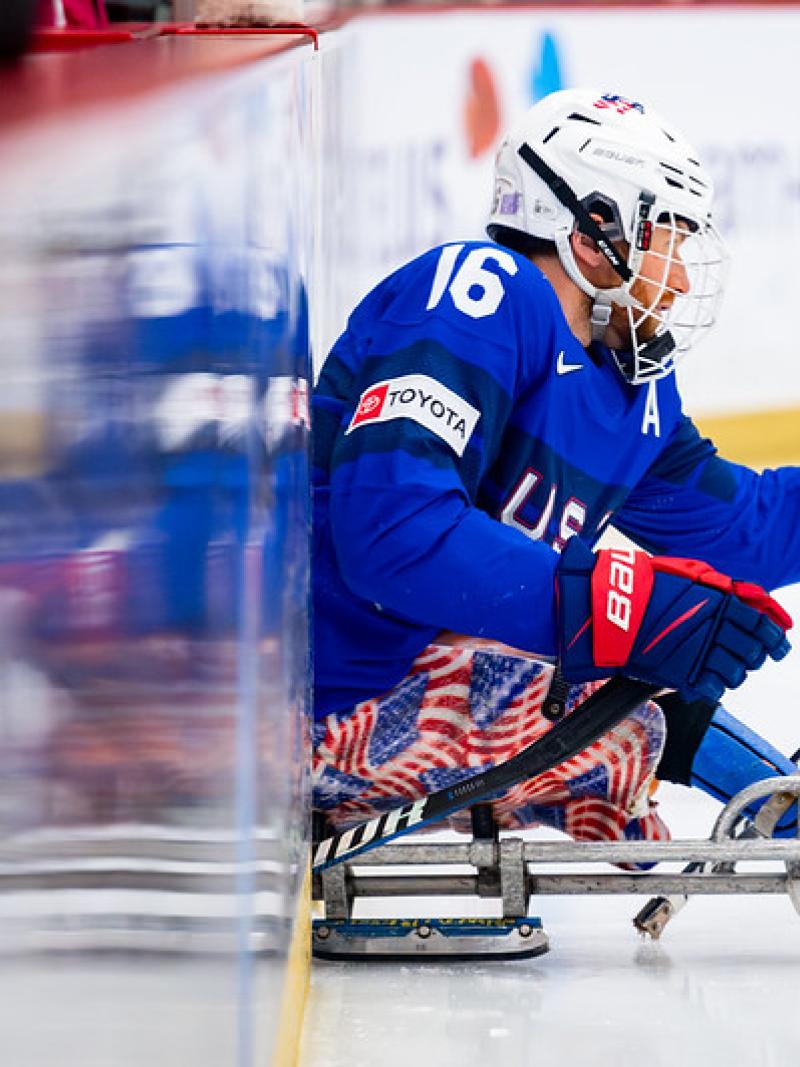 A male Para ice hockey player entering the rink