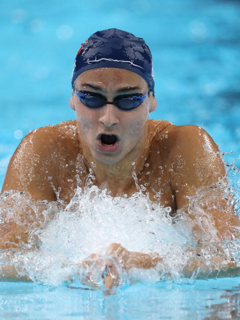 A male Para swimmer swimming breaststroke