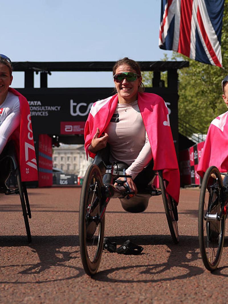 Three female wheelchair racers posing for pictures after the London Marathon