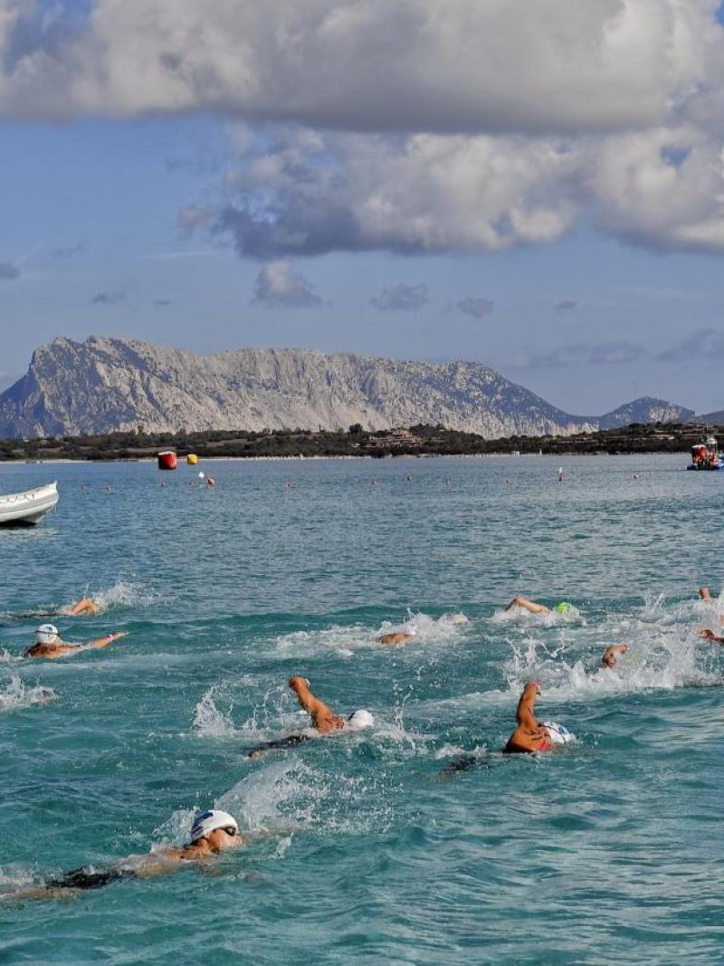 A group of 13 Para swimmers in an open water competition