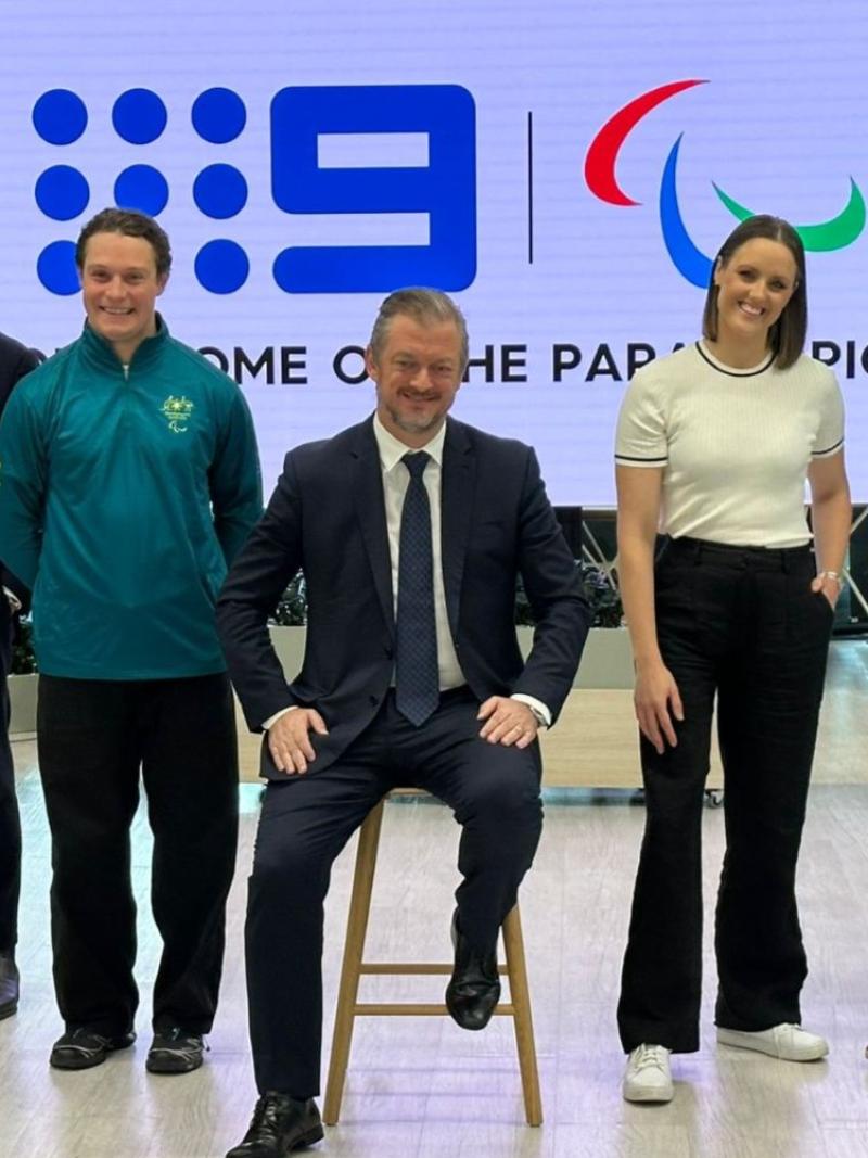 Five people pose for a photo