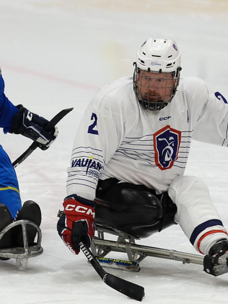 A Kazak and a French Para ice hockey player in a game