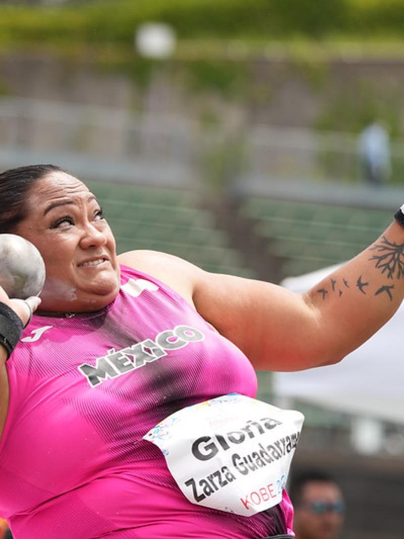 A female seated thrower competing in shot put
