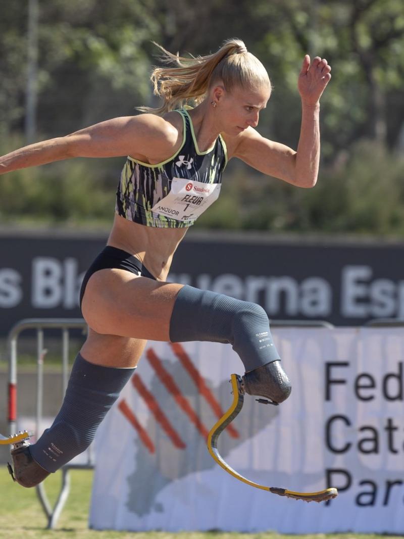 A woman in prosthetic legs running in a competition