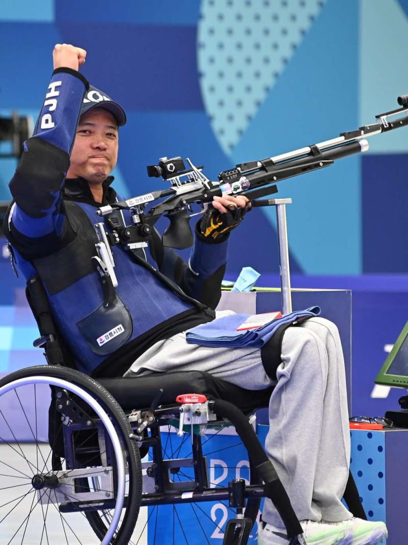 An athlete lifts his fist in air