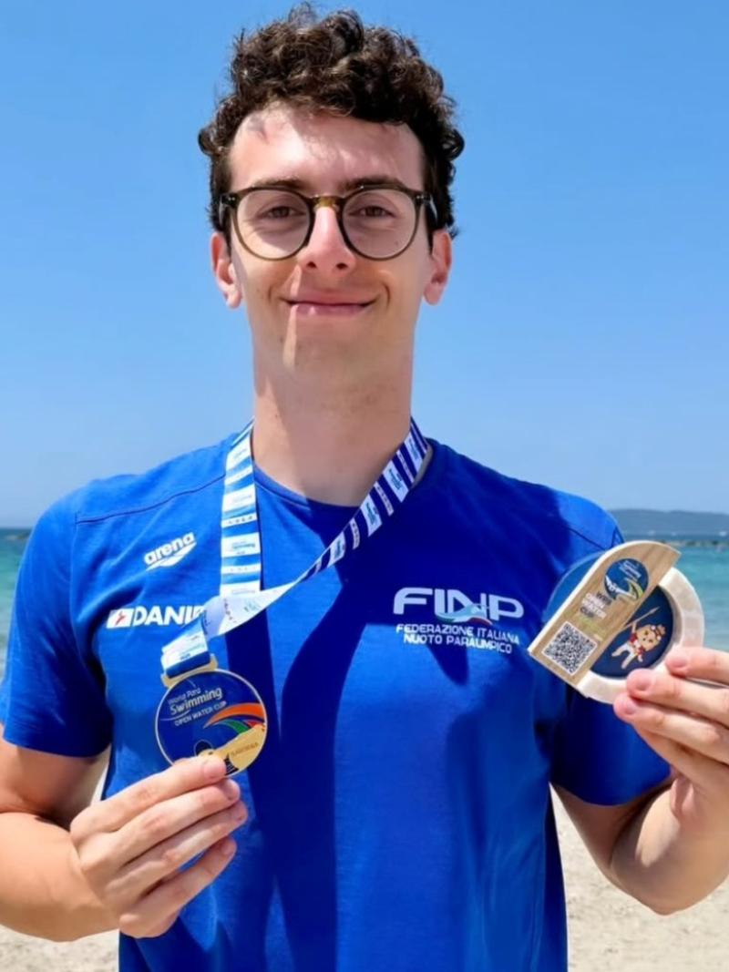 An athlete poses with his medal