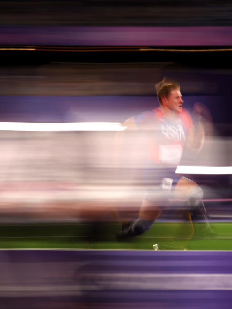 A man with prosthetic legs running in a track