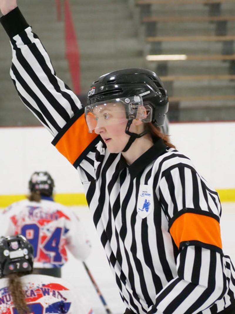 A female Para ice hockey official during a women's Para ice hockey game 