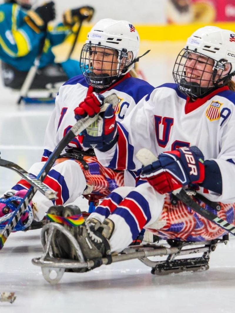 Three USA female Para ice hockey players celebrating