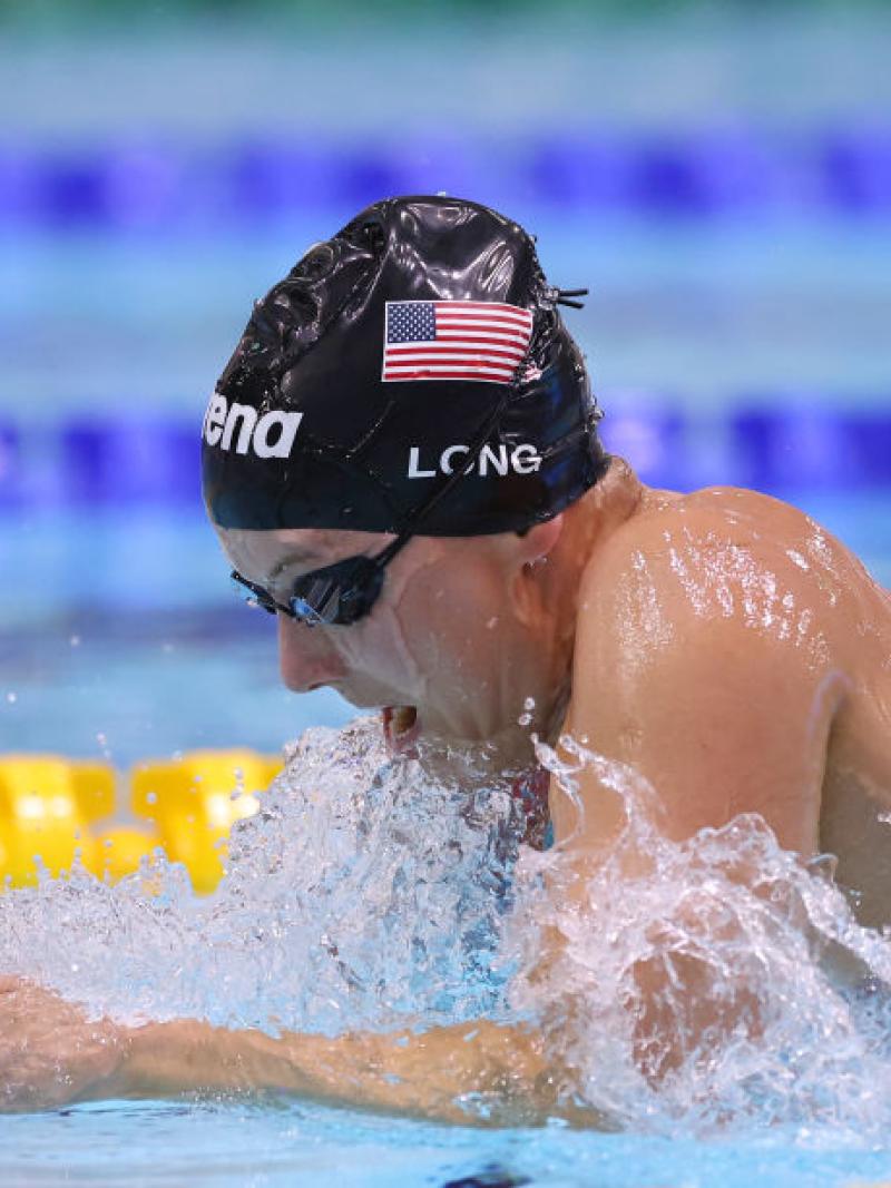 A female Para swimmer competing in breaststroke