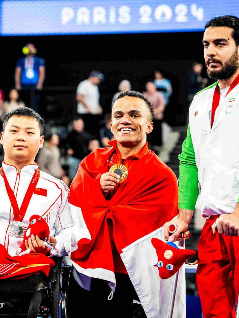Athletes pose on the podium