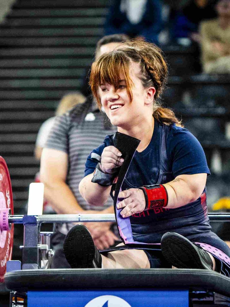 An athlete reacts in joy after a successful lift