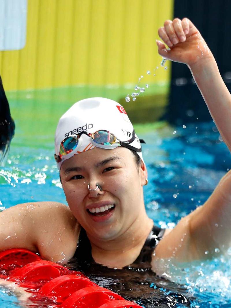 An athlete celebrates her gold medal