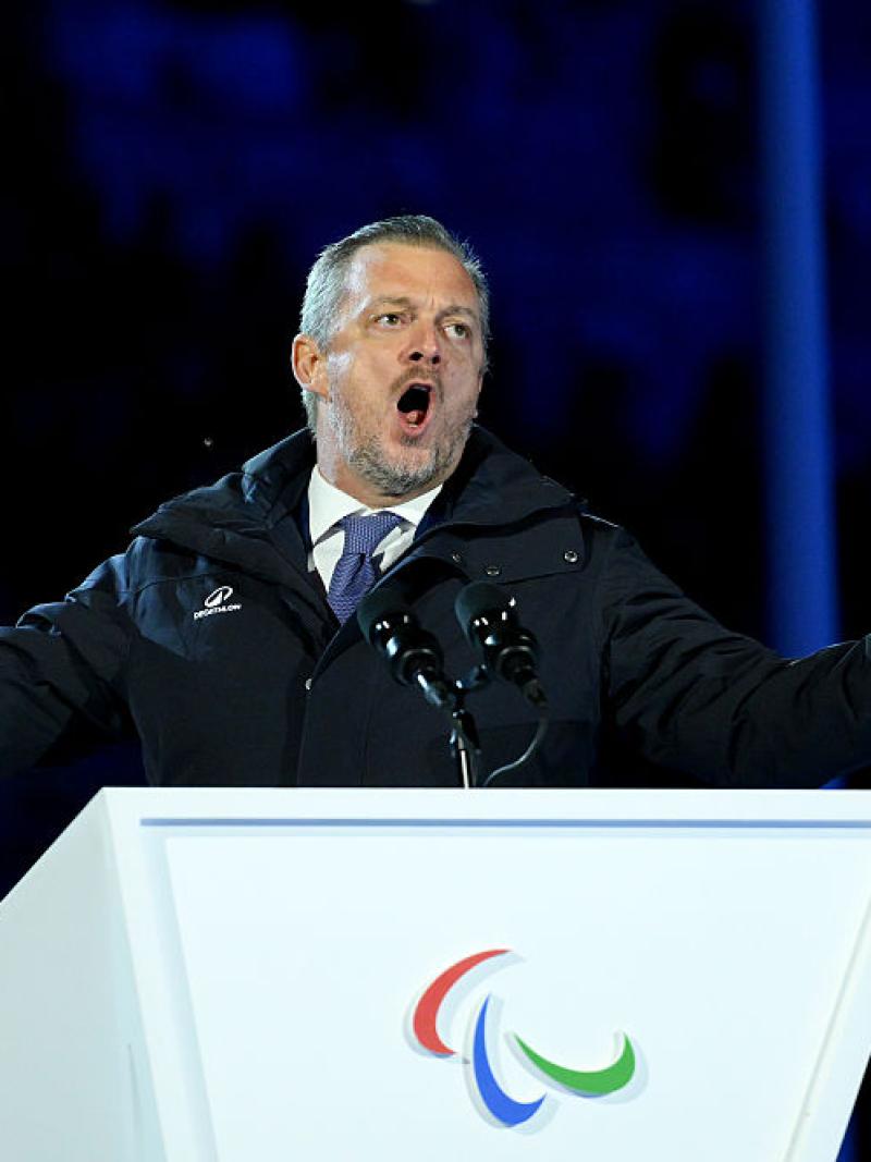 A man at a lectern deliving a speech