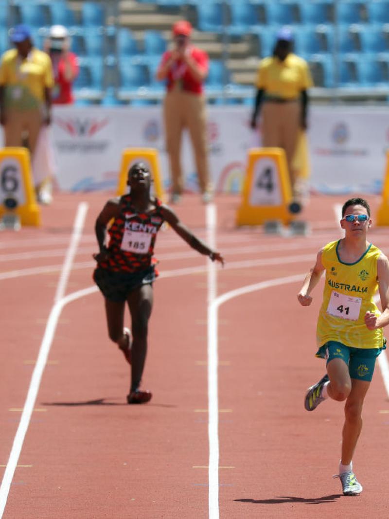 Four young Para athletes on a red track